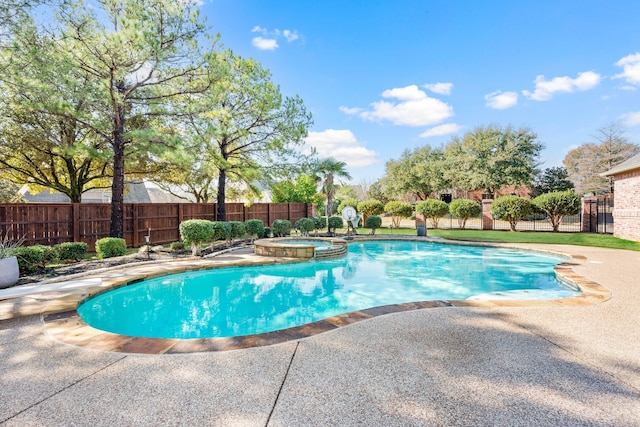 view of swimming pool featuring a patio area and an in ground hot tub