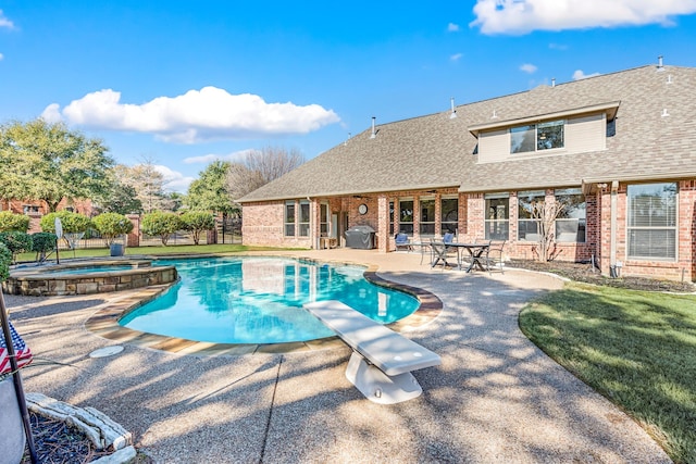 view of pool featuring a diving board, grilling area, a patio, and an in ground hot tub