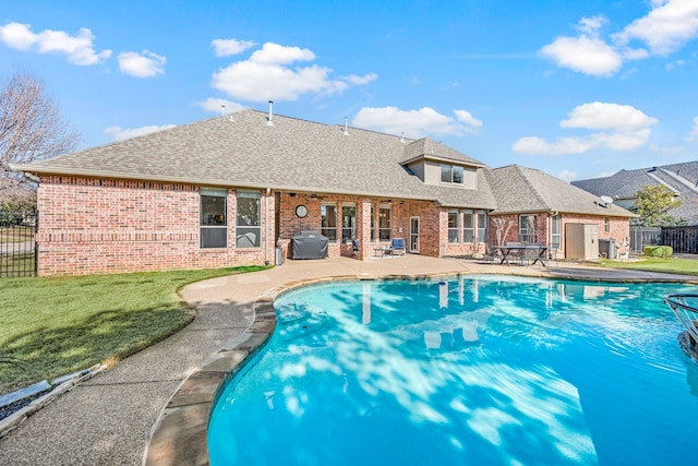 view of swimming pool with a yard and a patio area