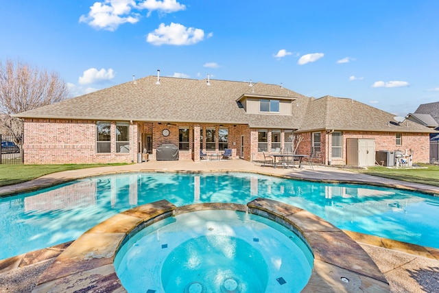 view of swimming pool featuring an in ground hot tub, a grill, a patio, and cooling unit