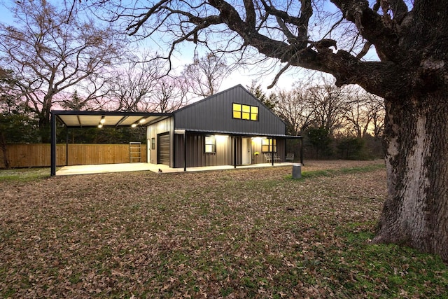 back of house at dusk with fence