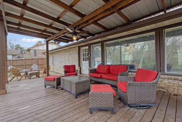 wooden deck with ceiling fan and outdoor lounge area