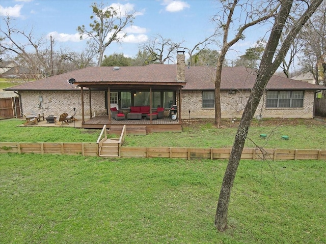 back of property with a wooden deck, an outdoor living space, and a yard