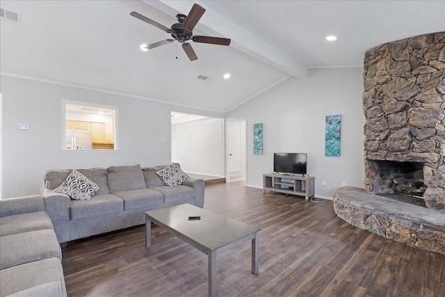 living room featuring a stone fireplace, vaulted ceiling with beams, crown molding, dark hardwood / wood-style floors, and ceiling fan