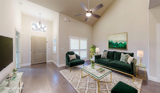 living room featuring ceiling fan with notable chandelier, high vaulted ceiling, and wood-type flooring