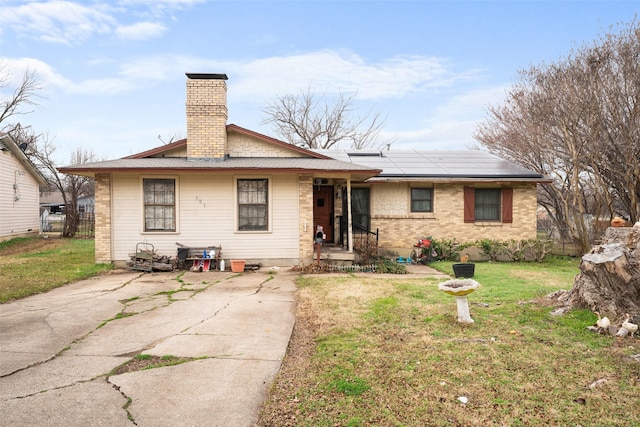 exterior space with a yard and solar panels