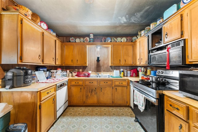 kitchen with dishwasher, sink, and electric range