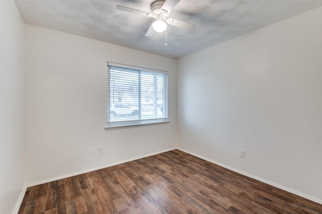 empty room featuring ceiling fan and dark hardwood / wood-style flooring