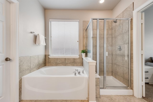 bathroom with tile patterned flooring and independent shower and bath