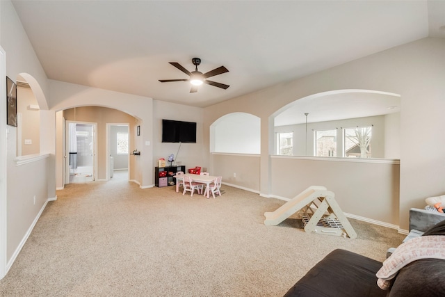 recreation room with ceiling fan, light colored carpet, and plenty of natural light