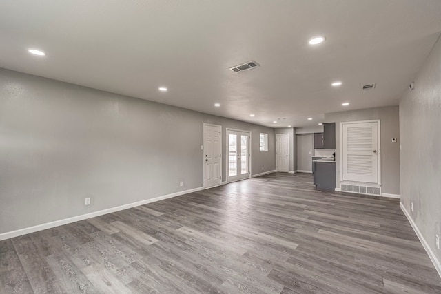 unfurnished living room with dark hardwood / wood-style floors