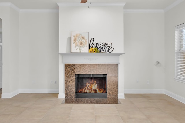 room details featuring a tiled fireplace, ornamental molding, and ceiling fan