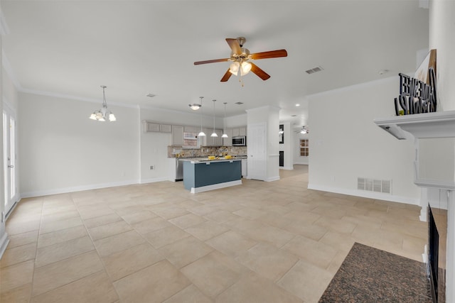 unfurnished living room with crown molding, light tile patterned floors, and ceiling fan with notable chandelier