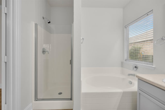 bathroom with vanity and plus walk in shower