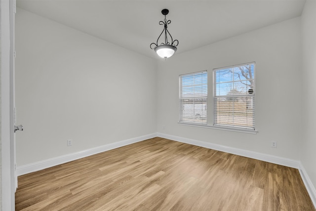 empty room with light hardwood / wood-style flooring