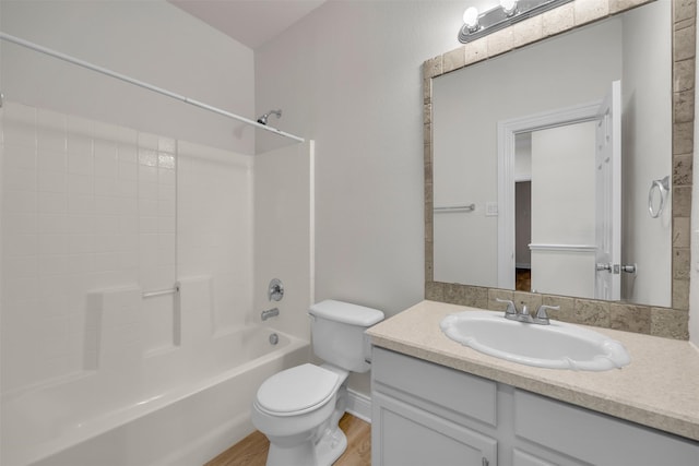 full bathroom with bathing tub / shower combination, hardwood / wood-style floors, vanity, and toilet