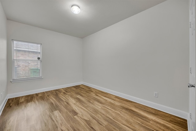 empty room with hardwood / wood-style floors