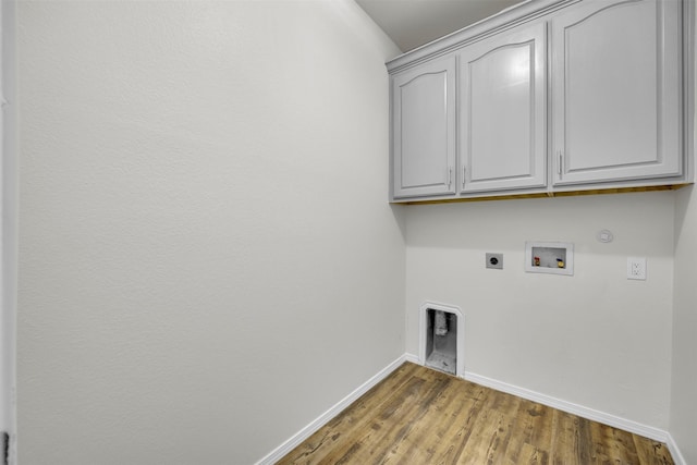 washroom featuring gas dryer hookup, cabinets, hookup for a washing machine, electric dryer hookup, and hardwood / wood-style floors