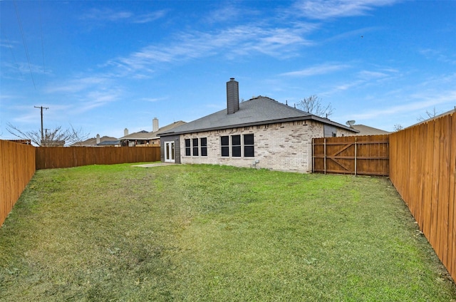 rear view of house featuring a yard