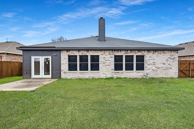 back of property featuring a lawn, a patio area, and french doors