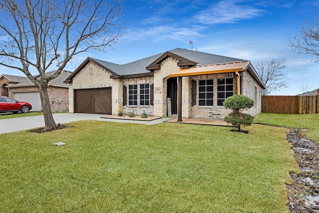 view of front of property with a garage and a front yard