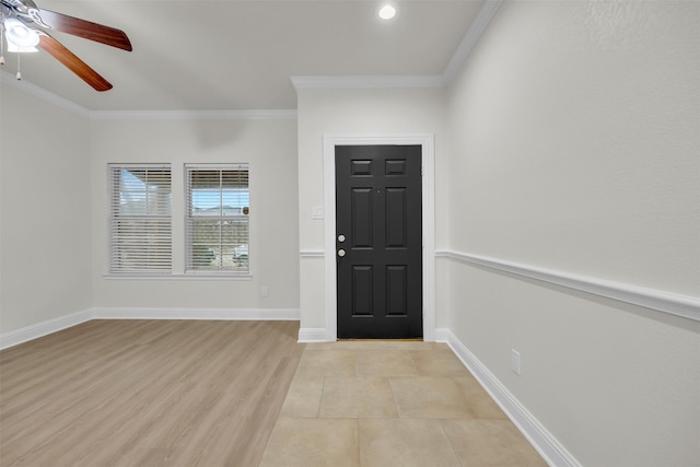 foyer with ornamental molding, ceiling fan, and light hardwood / wood-style flooring