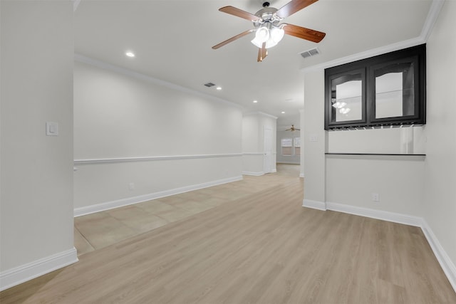 unfurnished room featuring ornamental molding, ceiling fan, and light hardwood / wood-style floors