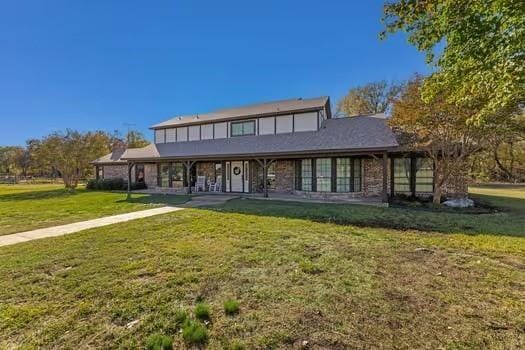 rear view of house with a yard