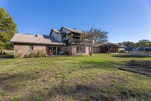 12 Brookhaven Dr, Lucas, TX 75002 - rear view of house with a lawn and a balcony