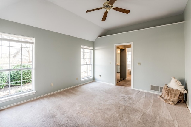 spare room with ceiling fan, light colored carpet, and lofted ceiling