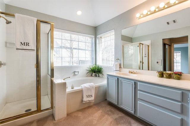 bathroom featuring independent shower and bath and vanity