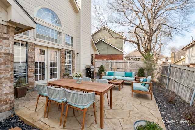 view of patio / terrace with area for grilling, outdoor lounge area, and french doors