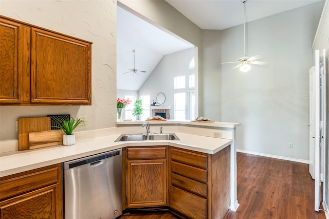 kitchen with vaulted ceiling, dishwasher, sink, ceiling fan, and kitchen peninsula