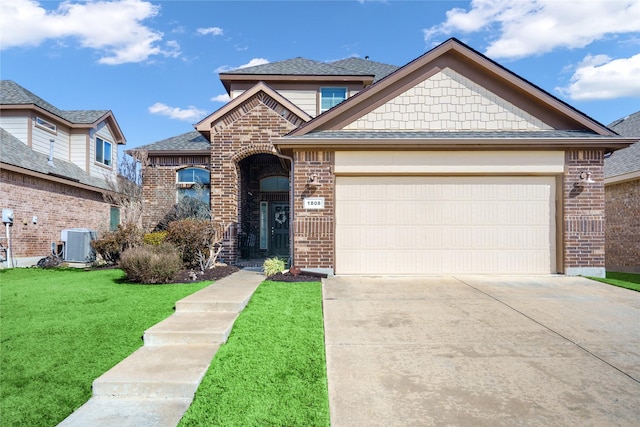 view of front of home with driveway, a front lawn, central AC, and brick siding