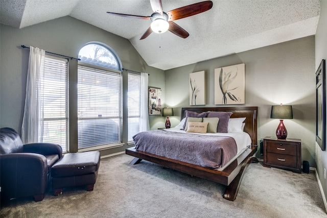 carpeted bedroom with ceiling fan, lofted ceiling, and a textured ceiling