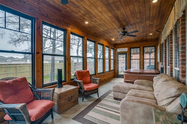 sunroom with wooden ceiling and ceiling fan