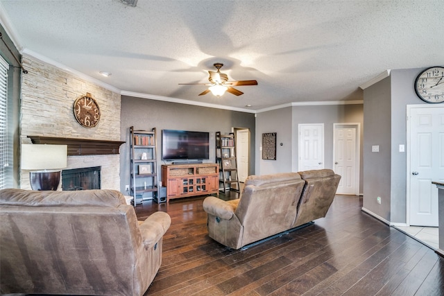 living room with ornamental molding, a fireplace, dark hardwood / wood-style flooring, and a textured ceiling