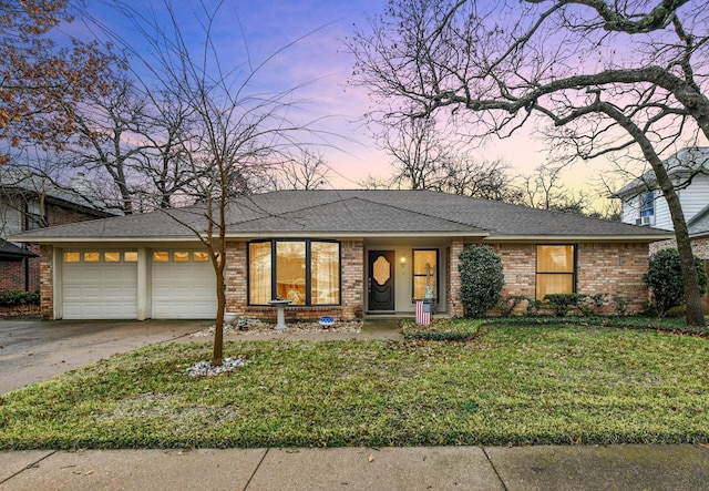 view of front of house featuring a garage and a lawn