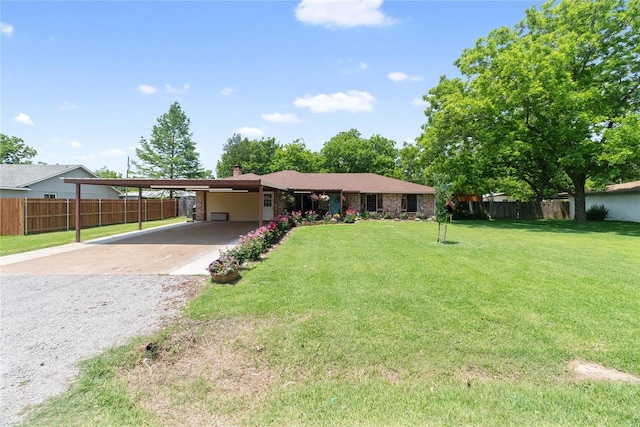 ranch-style house featuring a front lawn and a carport