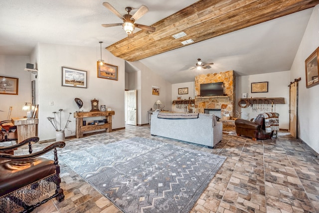 living room with a fireplace, lofted ceiling with beams, and ceiling fan