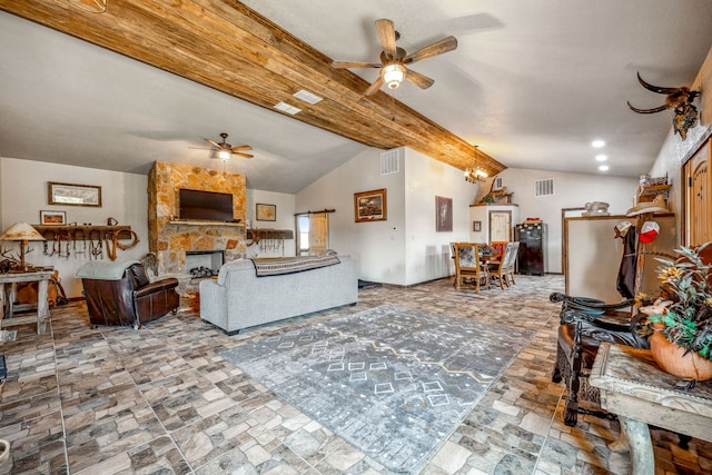 living room featuring a stone fireplace, vaulted ceiling with beams, and ceiling fan with notable chandelier