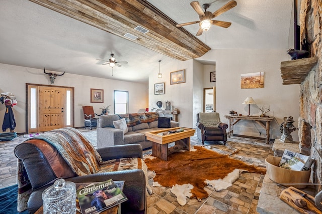 living room with ceiling fan and a textured ceiling