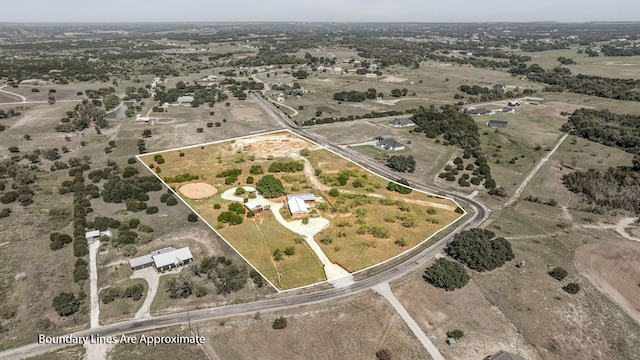 birds eye view of property with a rural view