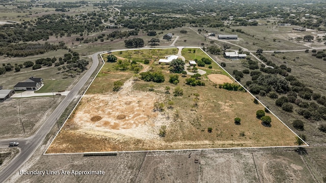 birds eye view of property with a rural view