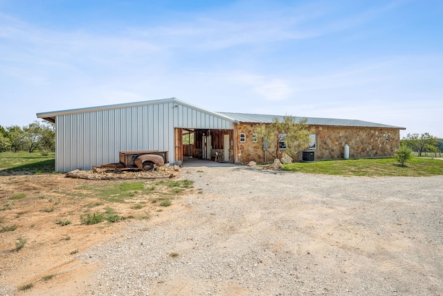 view of front facade featuring an outbuilding and cooling unit