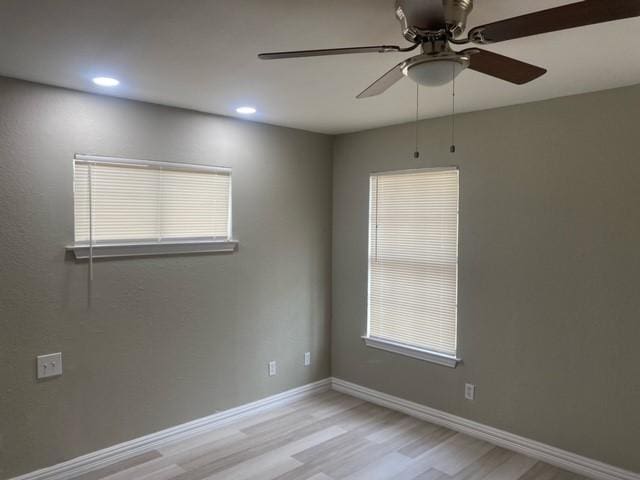 unfurnished room with ceiling fan and light hardwood / wood-style flooring