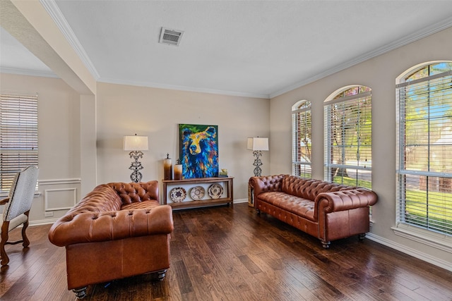 living room featuring dark wood-type flooring, a healthy amount of sunlight, and crown molding