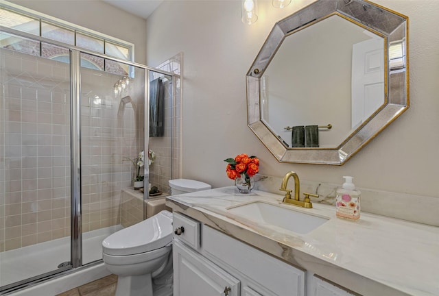 bathroom featuring walk in shower, vanity, and toilet