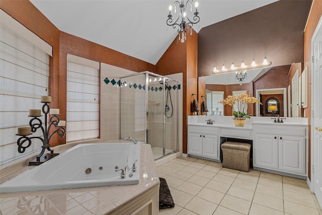 bathroom featuring tile patterned flooring, vaulted ceiling, separate shower and tub, and vanity