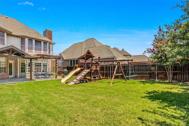 view of yard featuring a playground and a patio